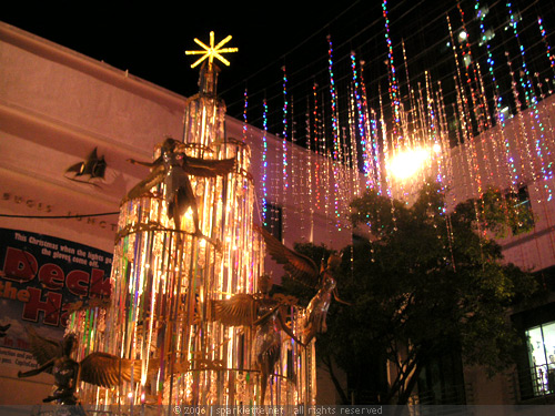 Shiny Christmas tree with angels at Bugis Junction at night