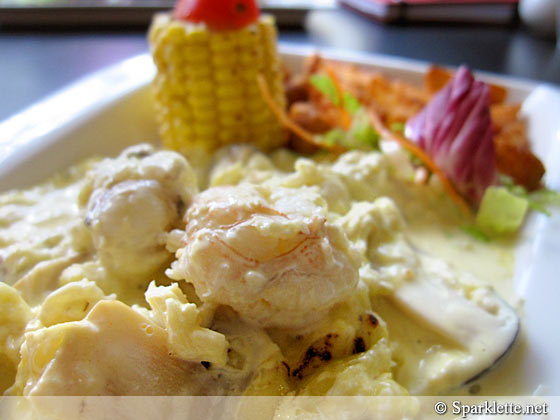 Crayfish and crab meat thermidor, corn on cob and potato wedges