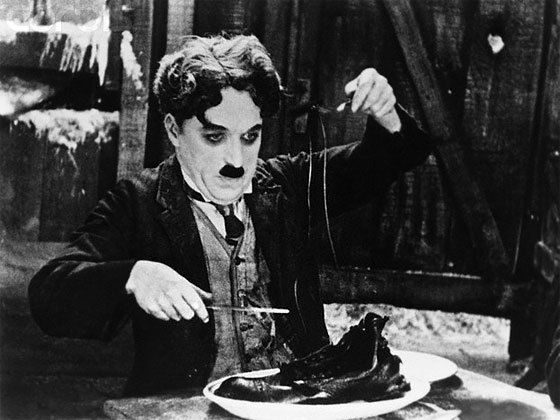 Charlie Chaplin: The Tramp eats his own shoe in The Gold Rush