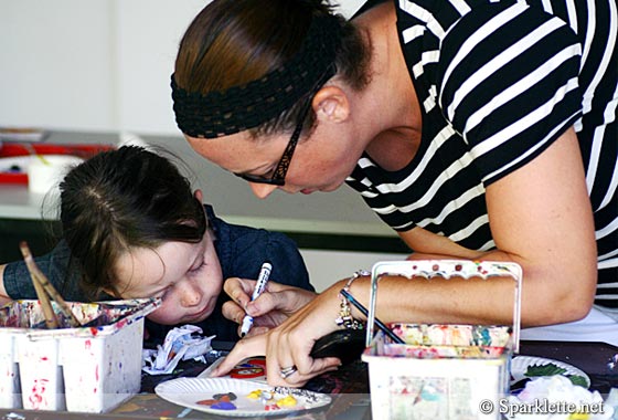 Mother helping daughter with arts and crafts at Scoop of Art, Marine Parade Community Club, Singapore
