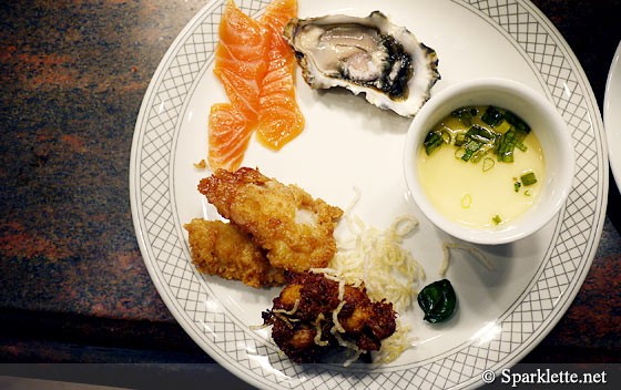 Clockwise from top: Fresh oysters, chawanmushi, turmeric chicken, deep fried fish, salmon sashimi