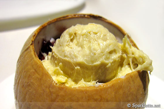 Chilled durian purée with purple rice purée served with ice cream in young coconut