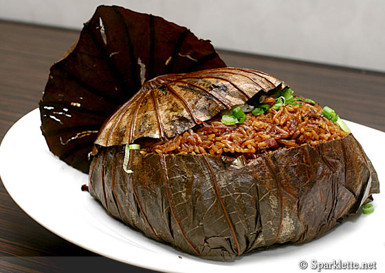 Steamed rice with assorted preserved meat in lotus leaf