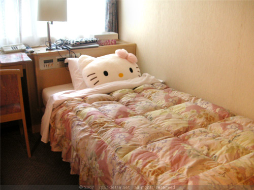 My bed in our hotel room in Kyoto, with my Hello Kitty cushion