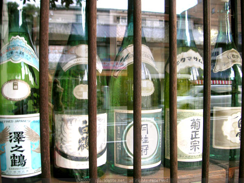 Big bottles in glass cabinet display