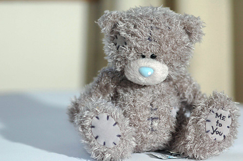 Grey teddy bear with hot sale patches