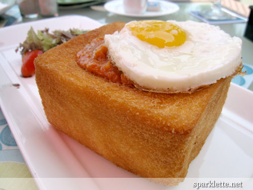 Sunnyside up on prawn bolognaise served in a toast box